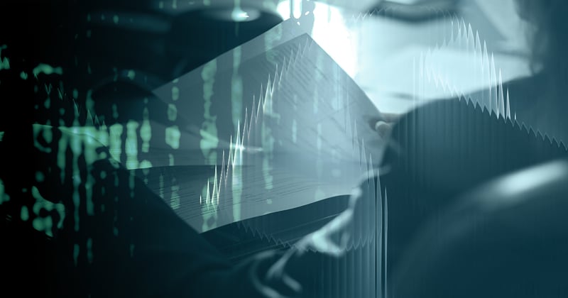 A person reviews papers at a deak with digital rain overlaid on the image.