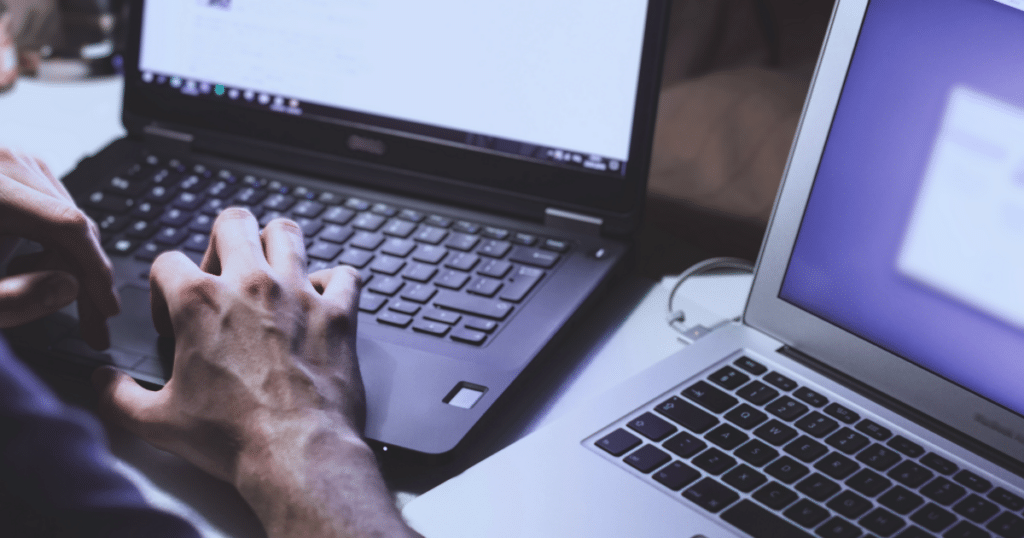 Two laptops used by one person, whose hands are in frame. This demonstrates the importance OSINT will have for the new EU AML package.